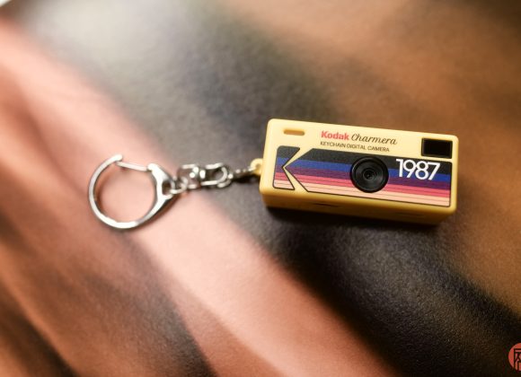 Why You Shouldn't Buy the Kodak Charmera A small Kodak keychain digital camera with 1987 printed on it, lying on a blurred surface.