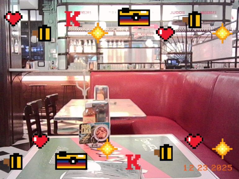 Empty diner booth with pixelated hearts, coins, and treasure chests overlaid; date stamp reads 12-23-2025.