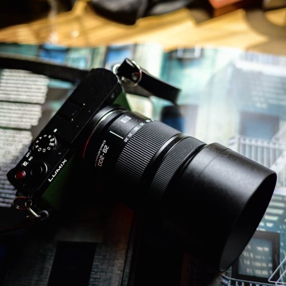 Camera resting on an open magazine with architectural images.