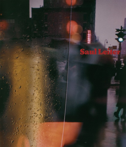 Rainy city street through a wet window with blurred lights and shadows; Saul Leiter in red text.