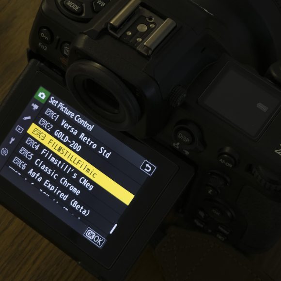 Nikon Imaging Recipes Now Rival Fujifilm Simulations A camera screen displays a menu of film simulation presets, including FILMSTILL/Filmic and Classic Chrome.