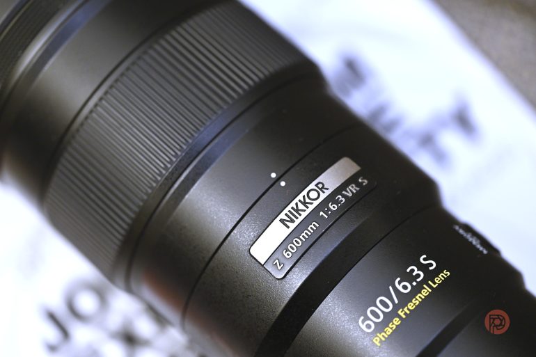 Close-up of a NIKKOR Z 600mm f/6.3 VR S Phase Fresnel camera lens with text details visible.
