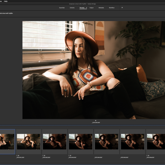 A woman in a hat sits on a couch by a window, shown in a photo editing software interface.
