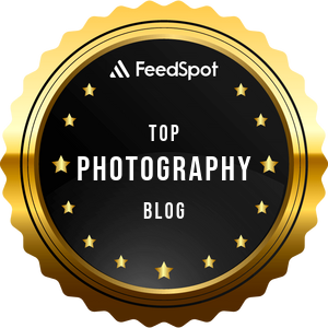 A Feedspot award badge for Top Photography Blog with a gold border and star design.