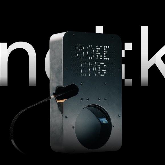 Knokke by Soke Looks Super Exciting For Analog Photographers A modern film scanning device with a digital display, angled against a black background with white text.