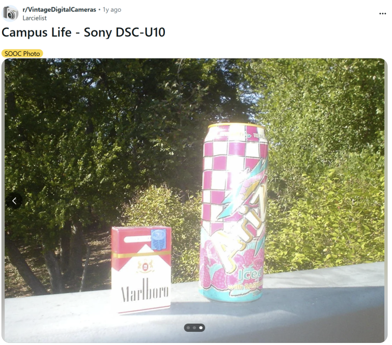 A pack of Marlboro cigarettes and an Arizona tea can on a ledge, with trees in the background.