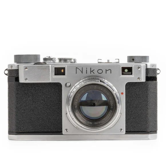 Vintage Nikon rangefinder camera with a silver and black body, photographed on a white background.